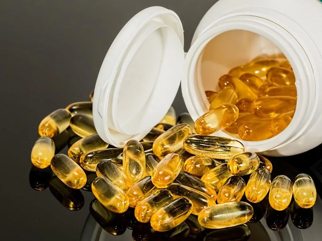 Dog probiotic supplement bottles and treats on a table